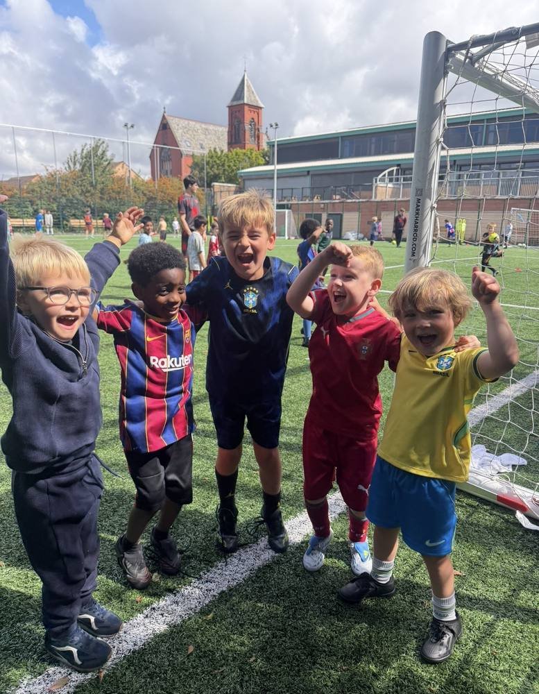Excited young players celebrating by the goal